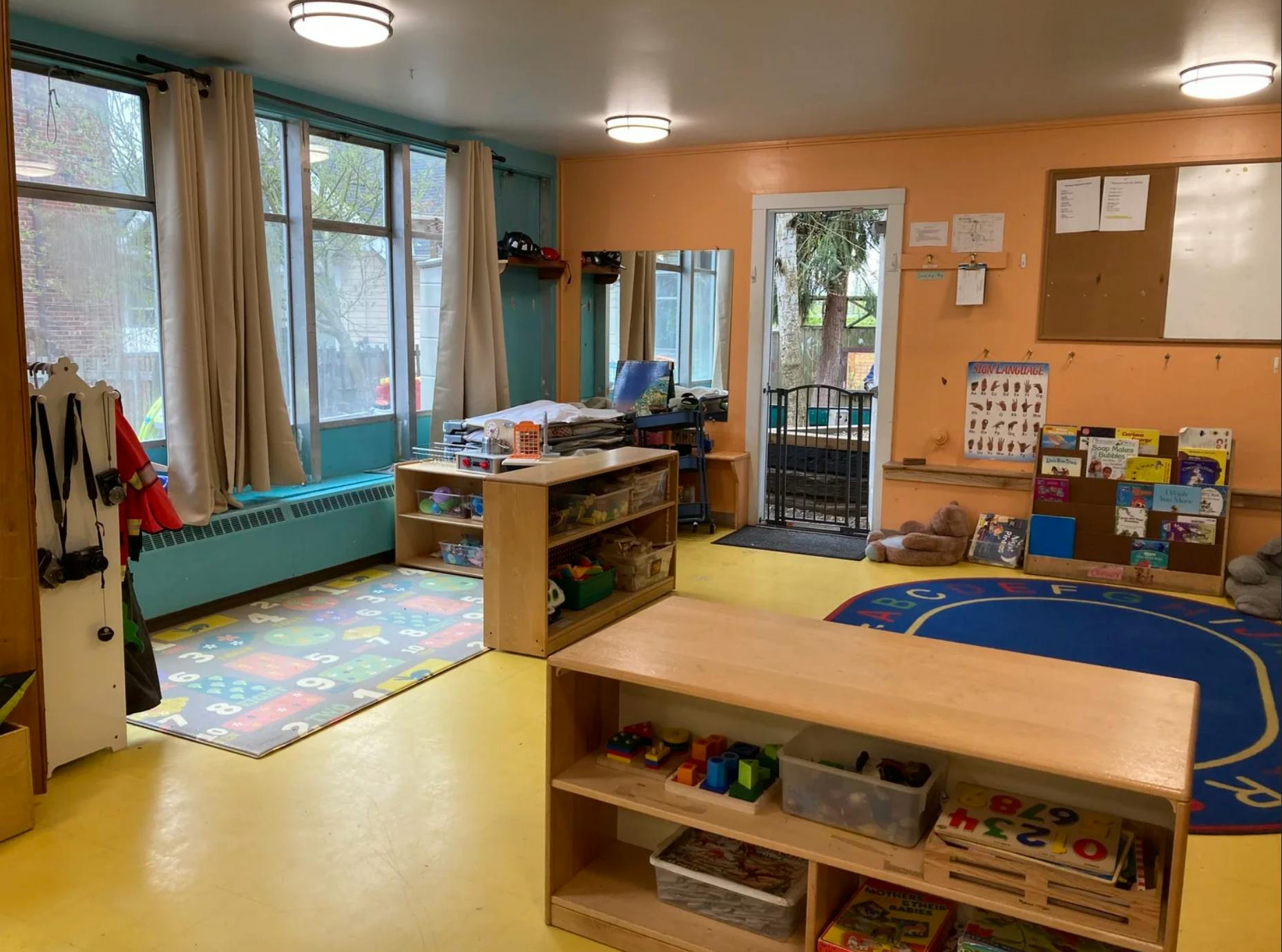 Classroom interior with play rugs and toy storage shelves