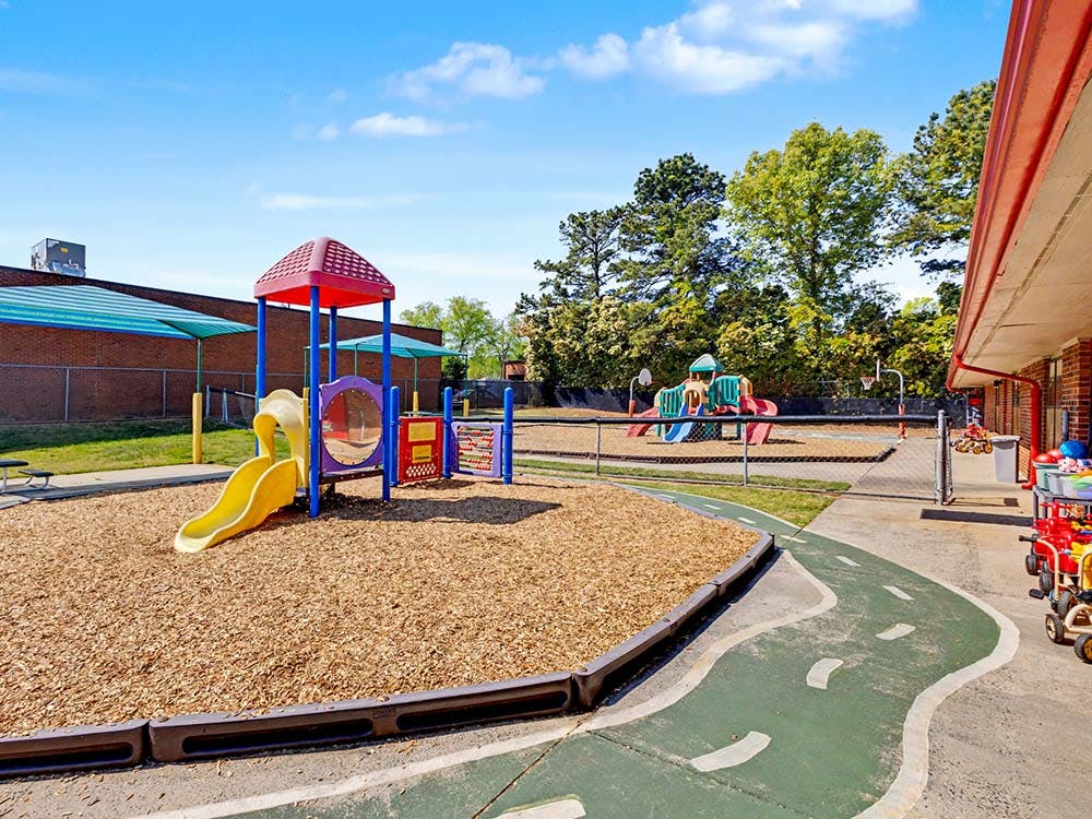 Playground with colorful slides and play structures on wood chips