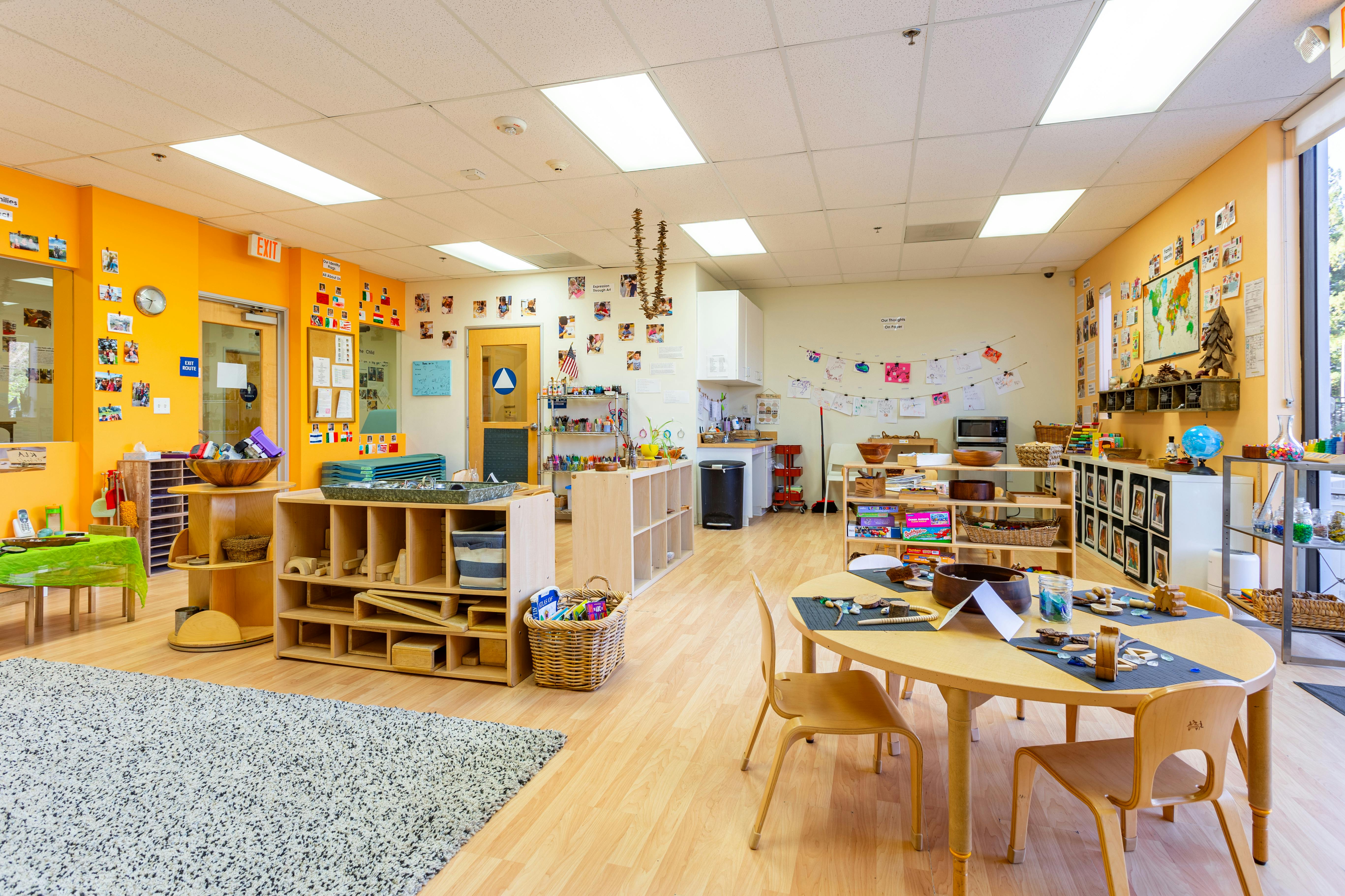 Empty classroom with tables, chairs, and shelves