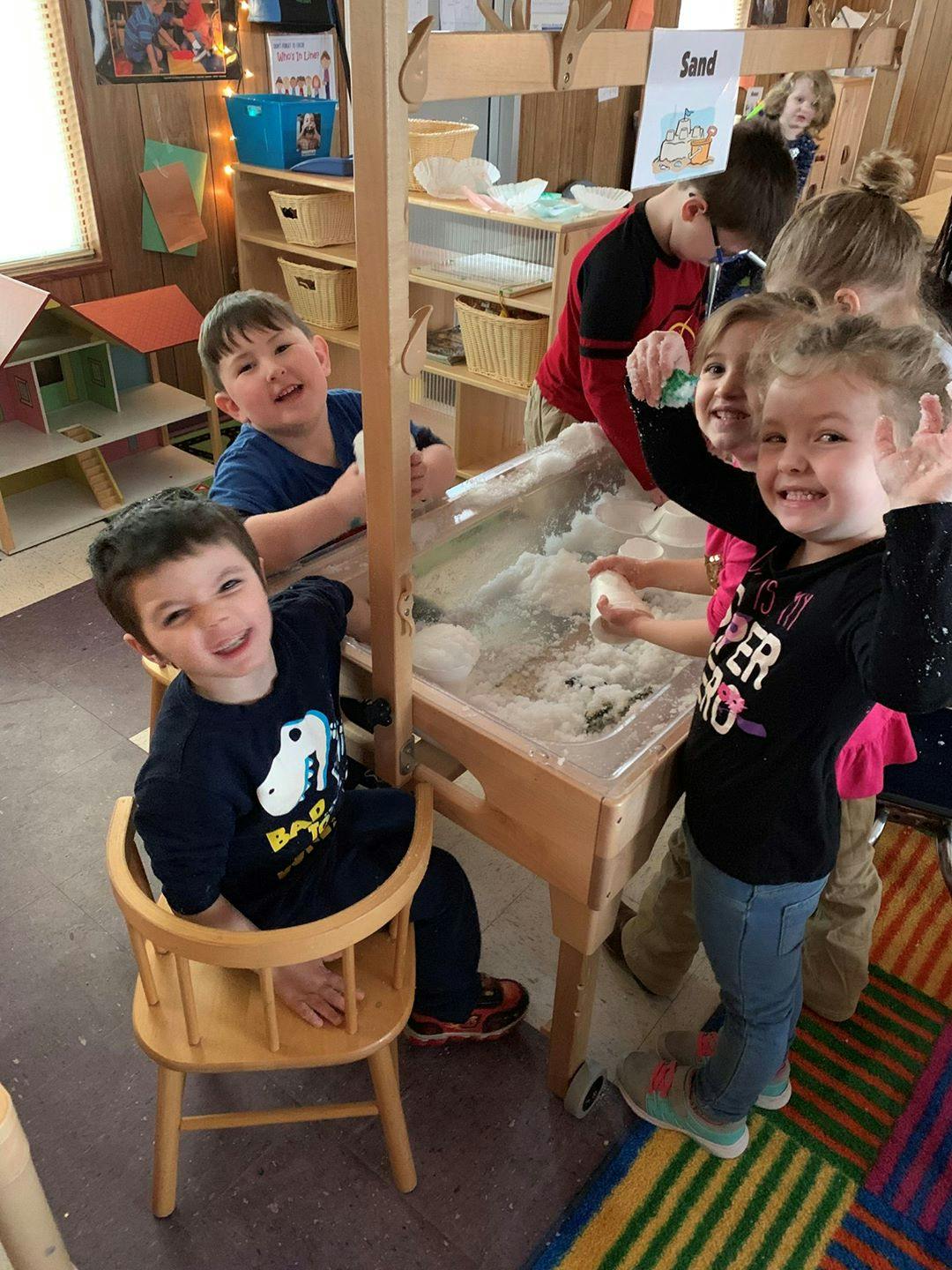 Children playing at a sand and water table