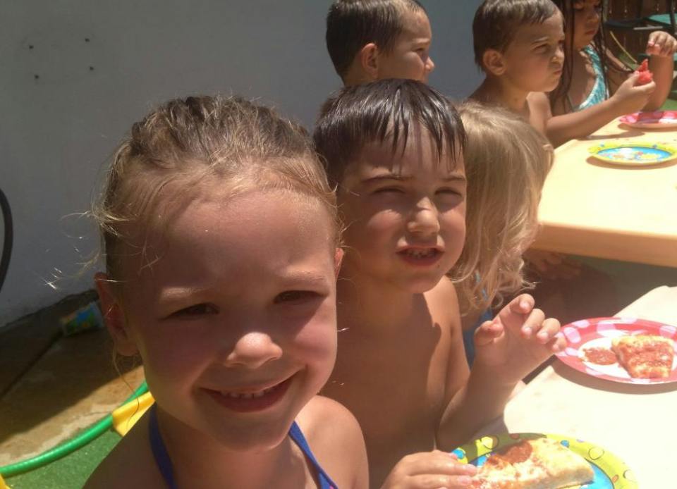 Children eating pizza at a table
