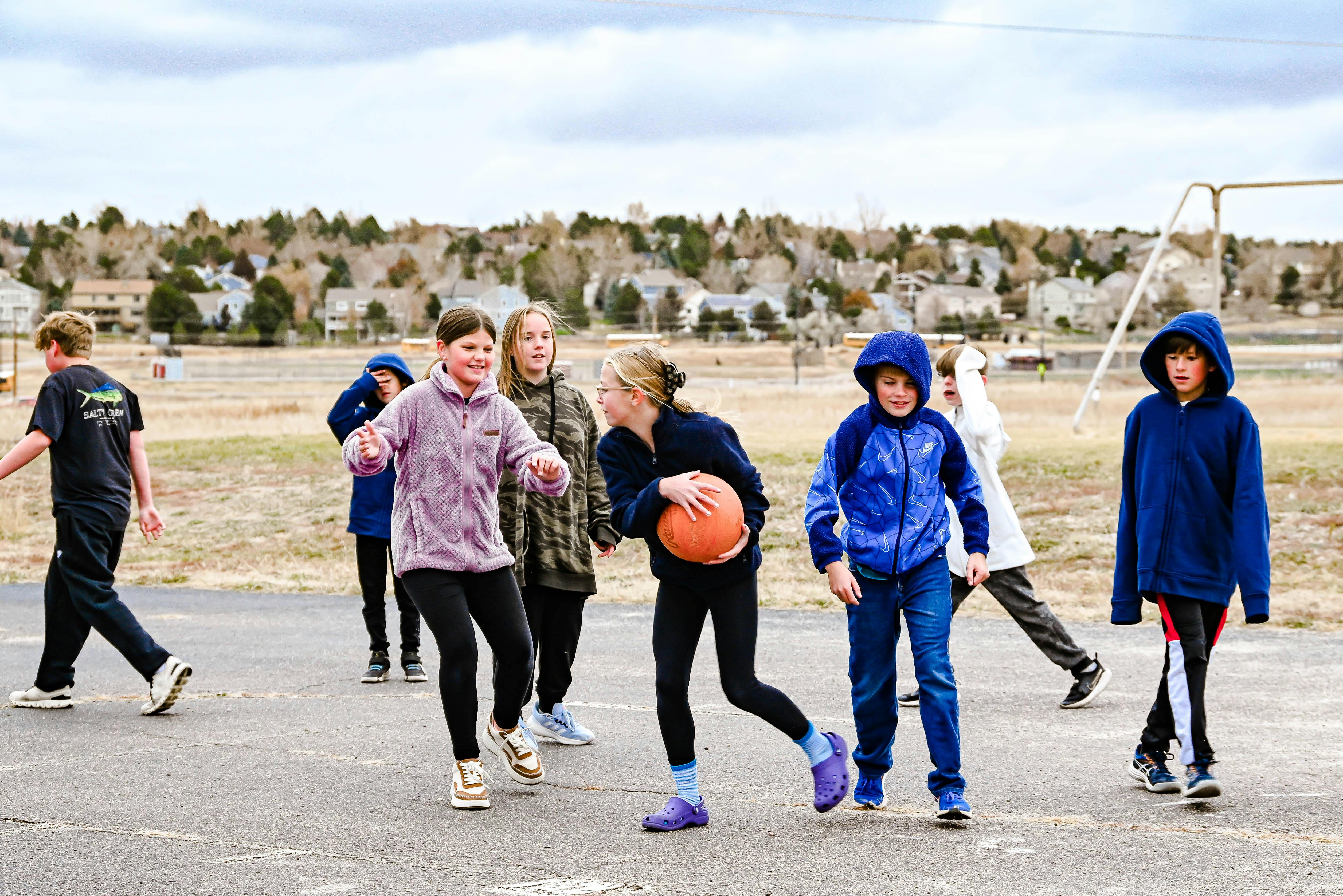 Children playing basketball outdoors