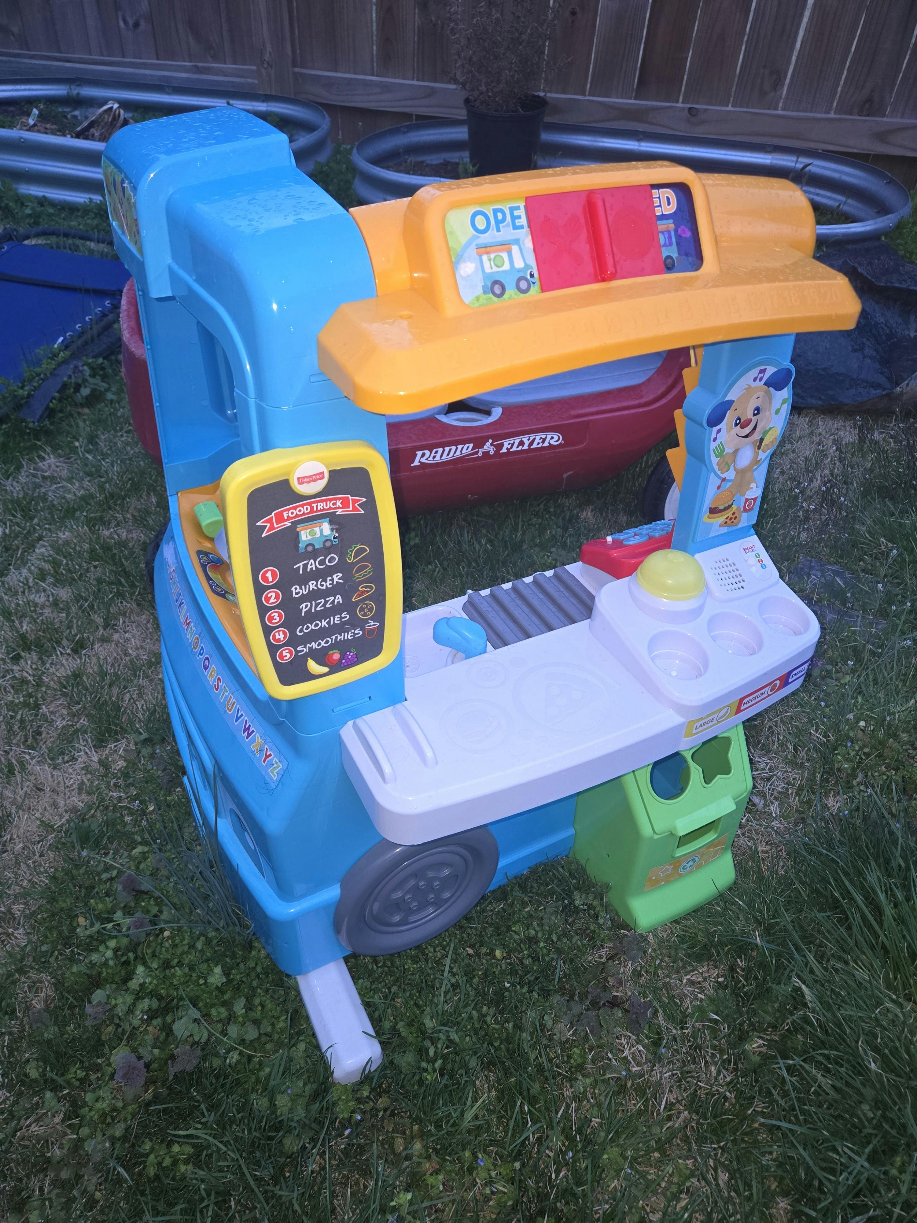 Blue and yellow toy food truck with a menu board