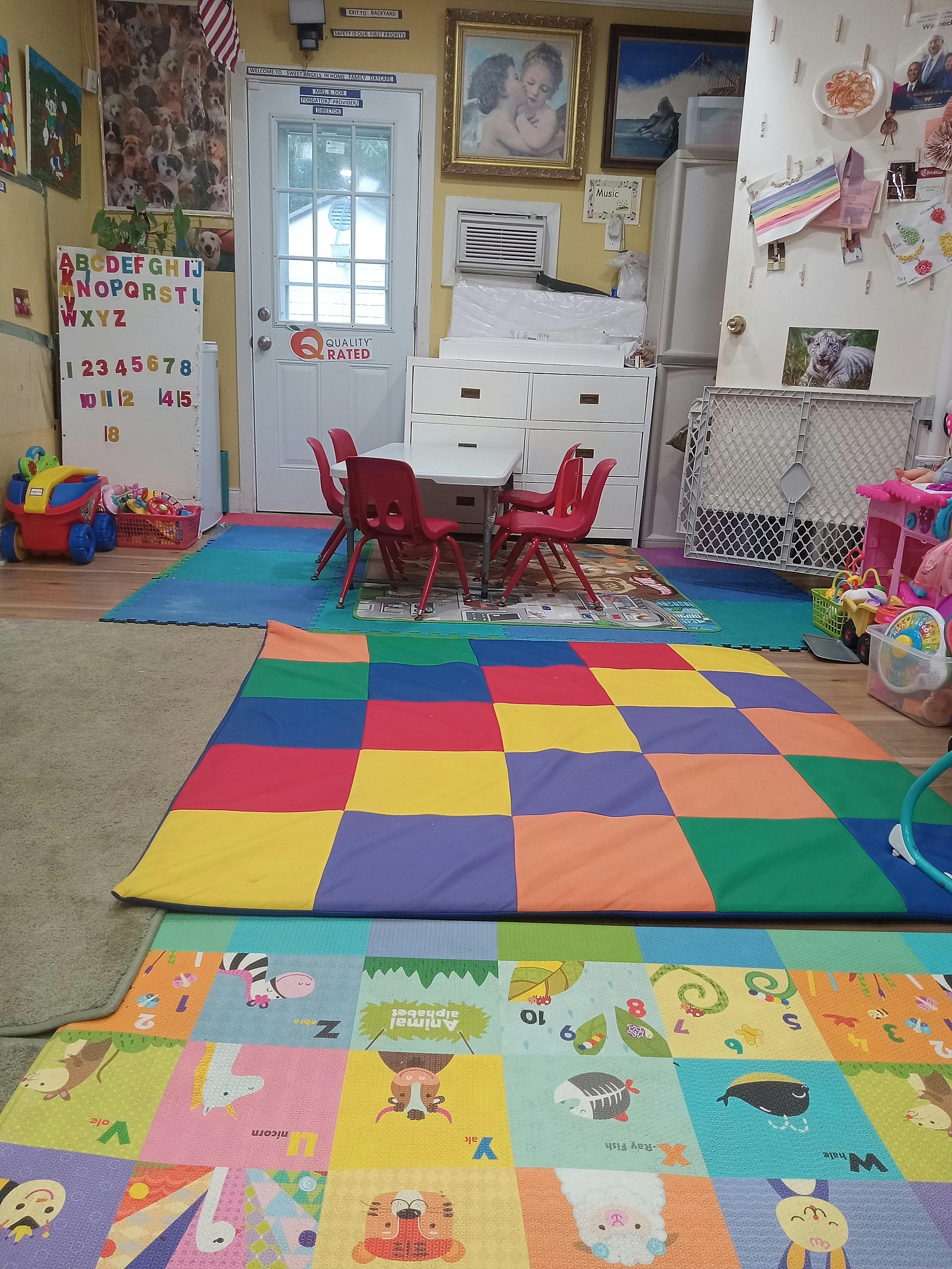 Child's playroom with colorful rugs, small table and chairs, and toys