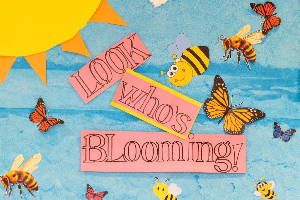 Craft display with text "LOOK WHO'S BLOOMING!" surrounded by butterflies and bees