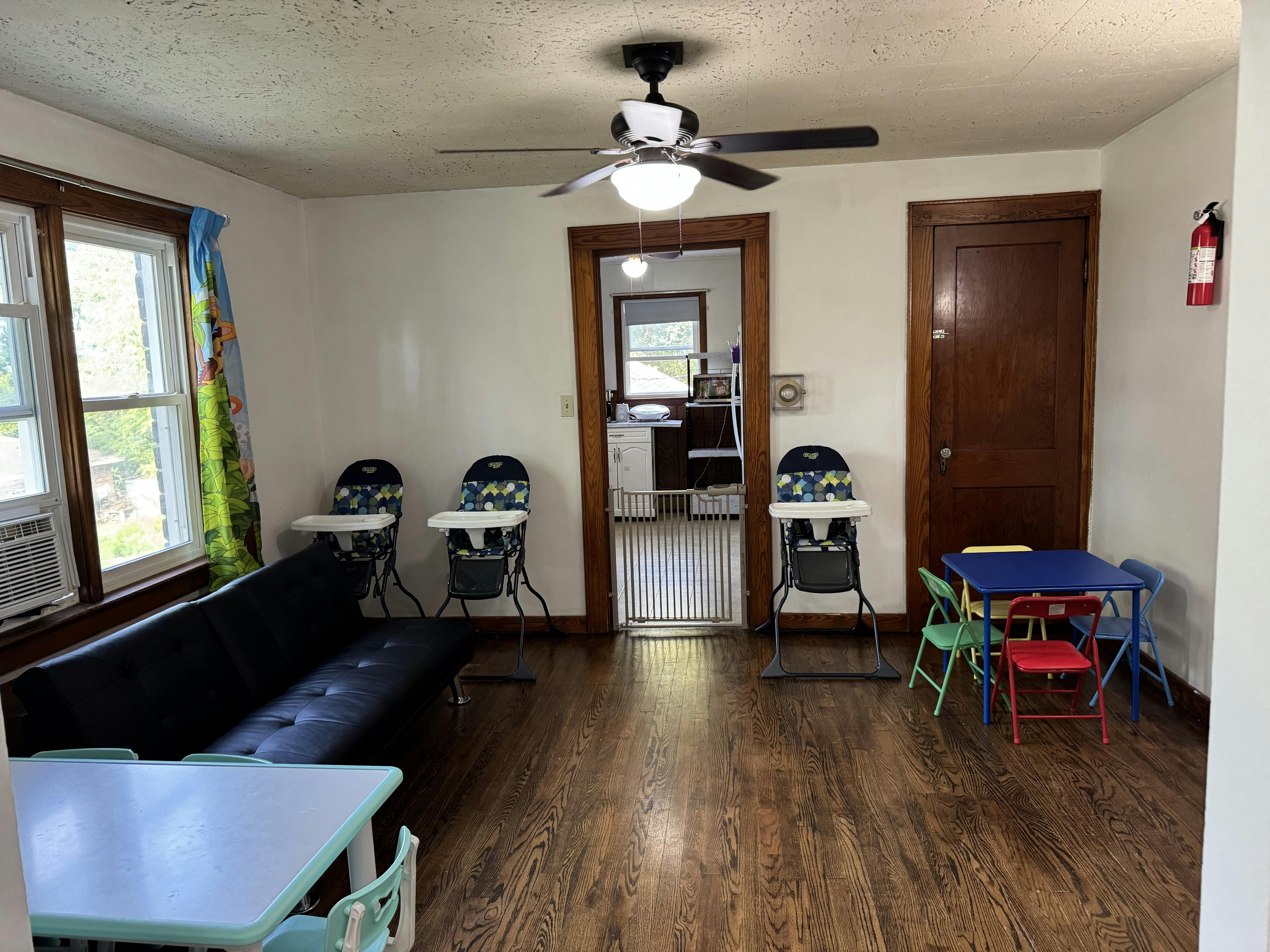 Living area with sofa, high chairs, and small table with chairs