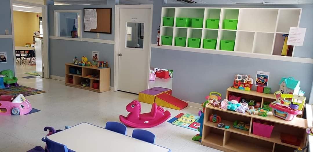 Playroom with toys, shelves, and a small table