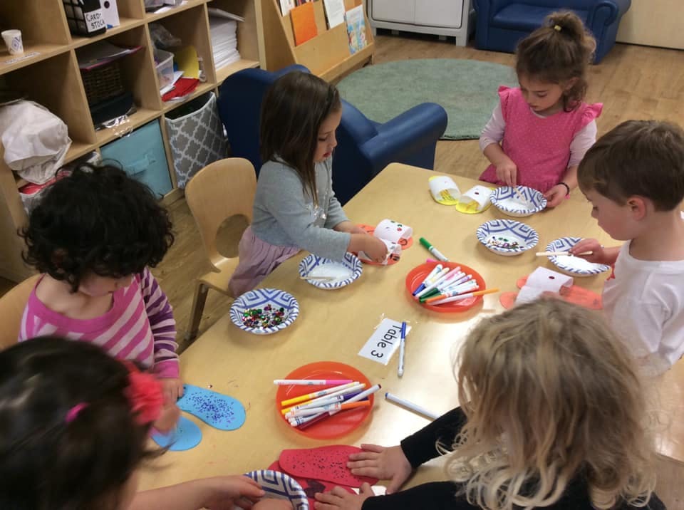 Children at a table doing an art activity