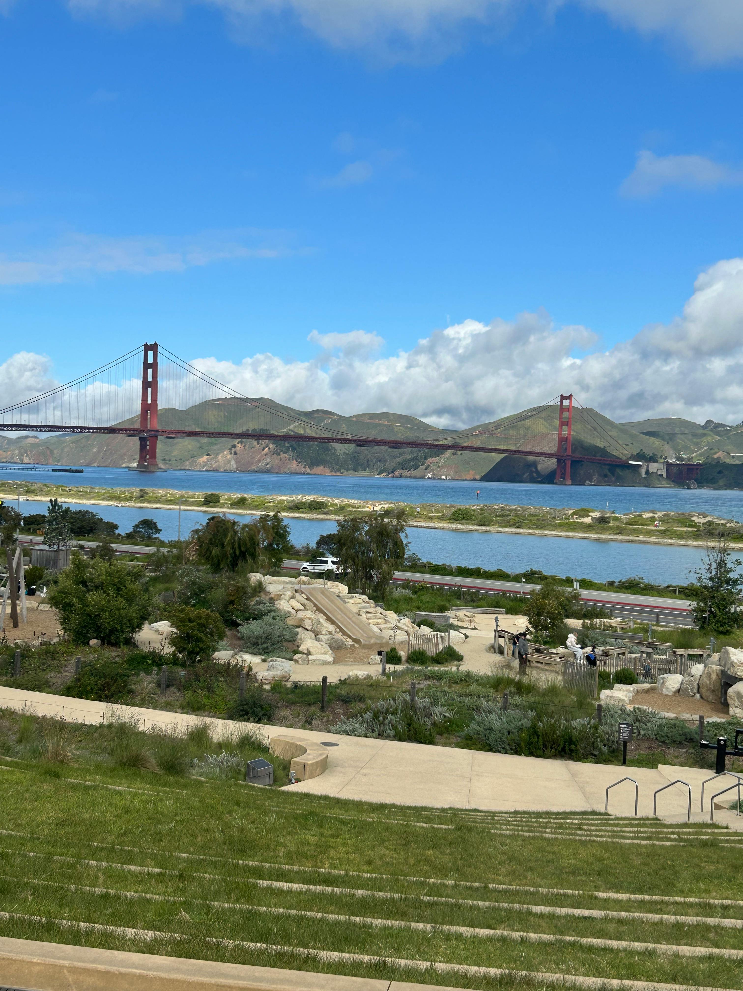 Golden Gate Bridge over water with hills in the background