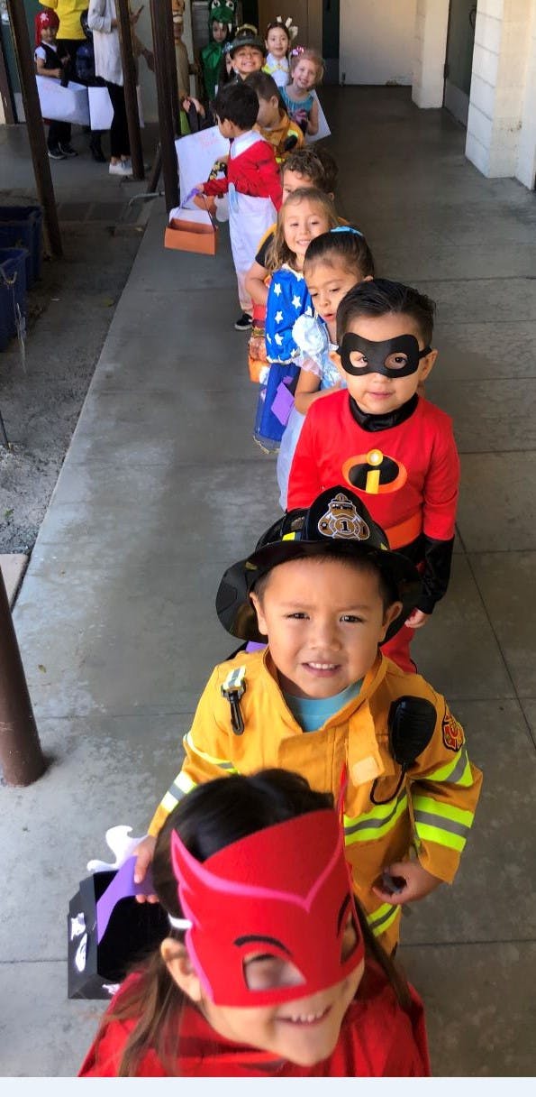 Children in costumes standing in a line