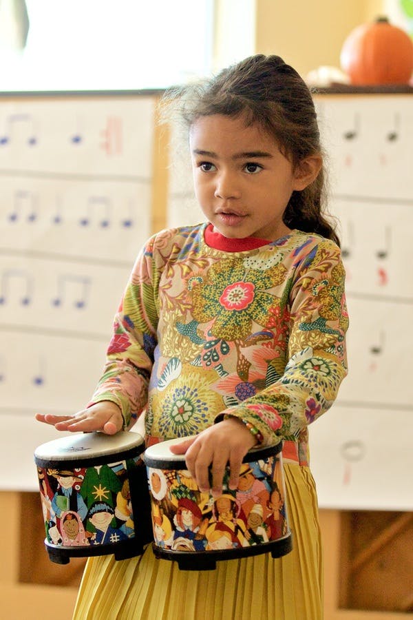 Child playing bongo drums