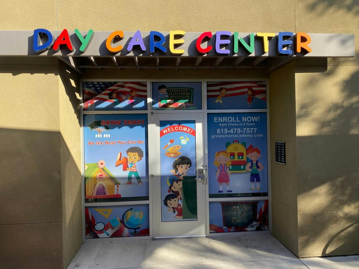 Day Care Center sign above a glass door with colorful children's drawings