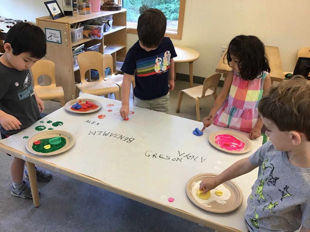 Children painting at a table