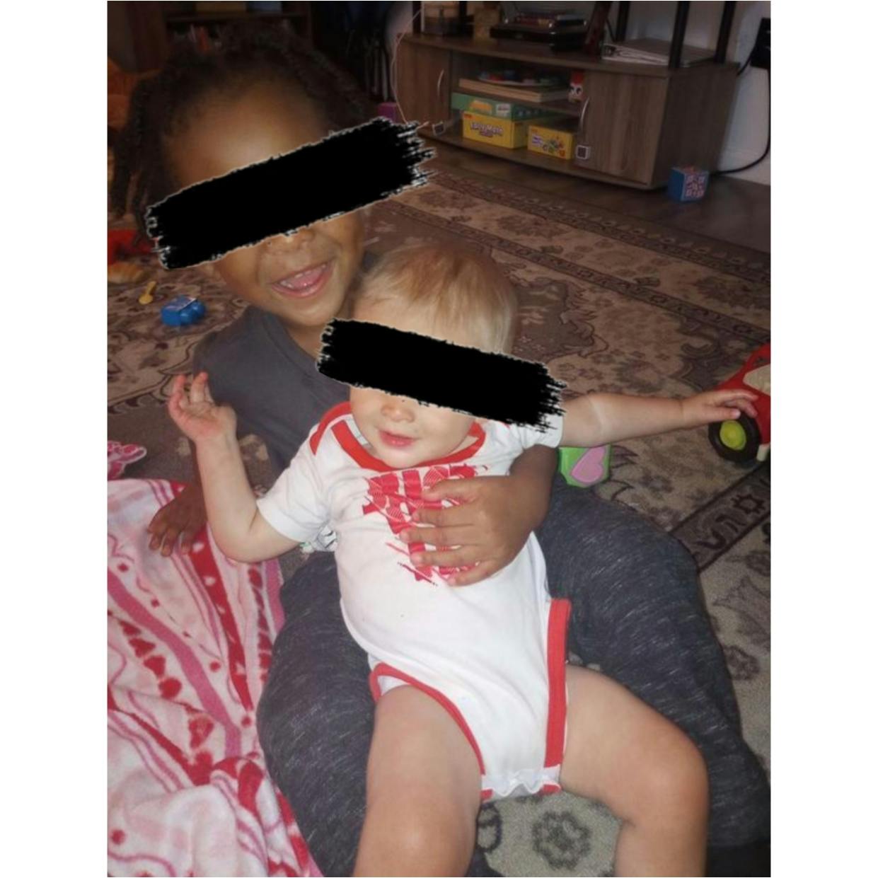 Child holding a baby