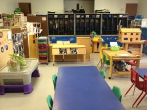Classroom with tables, chairs, and storage units