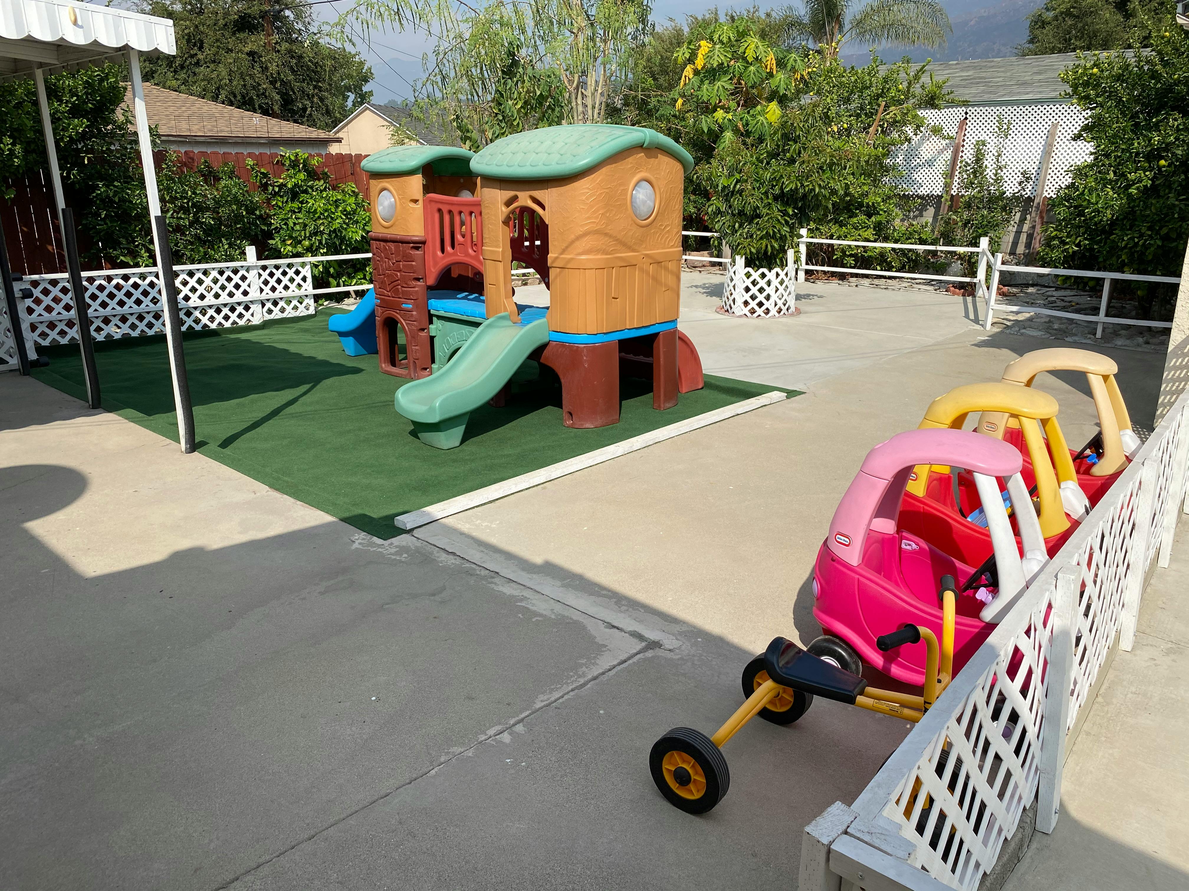 Playground with play structure and toy cars