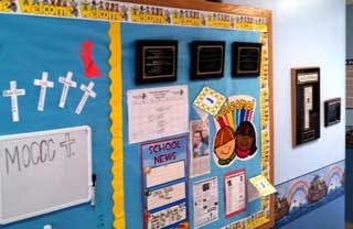 Bulletin board with papers, crosses, and a whiteboard