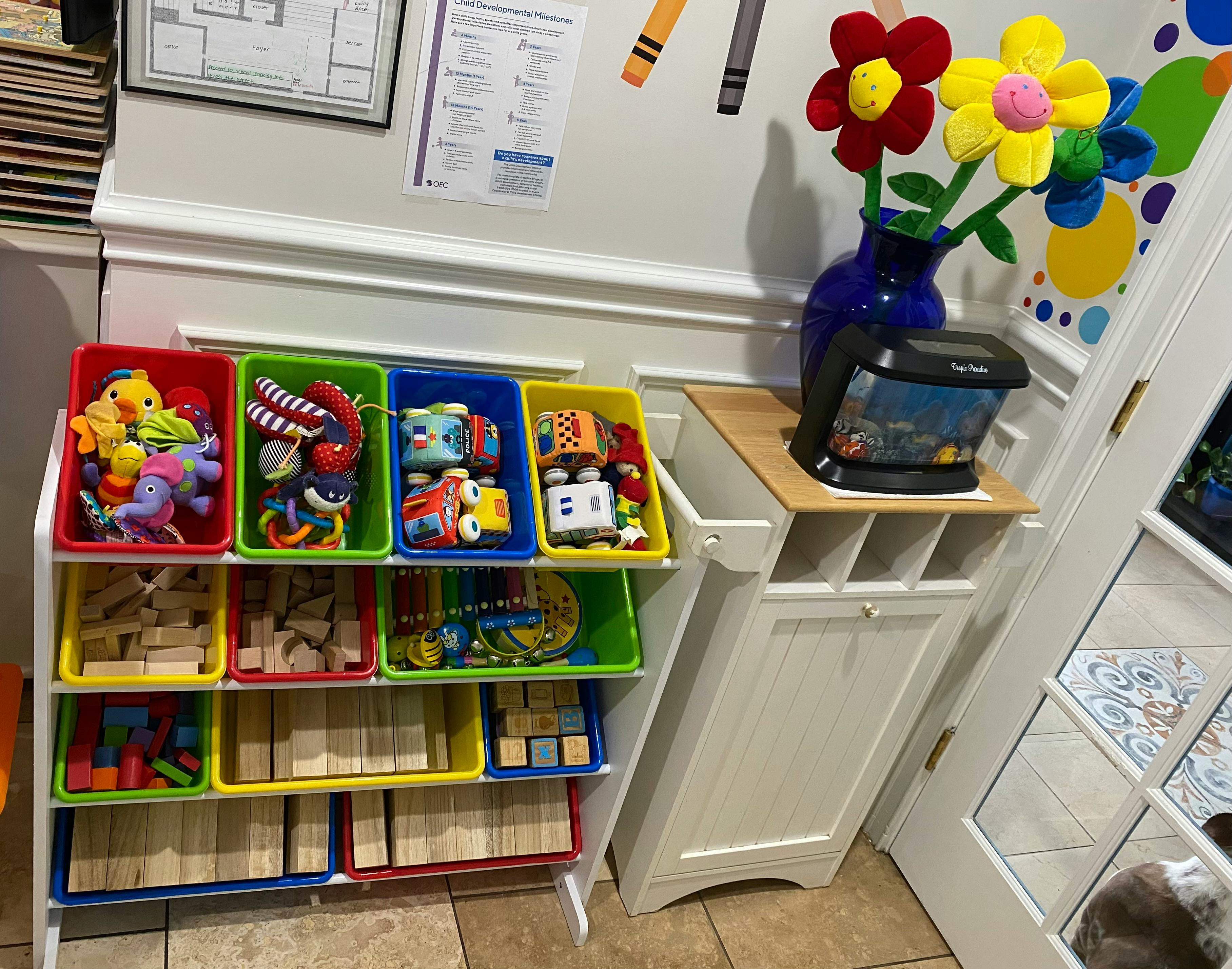 Toy storage unit with colorful bins filled with toys and blocks