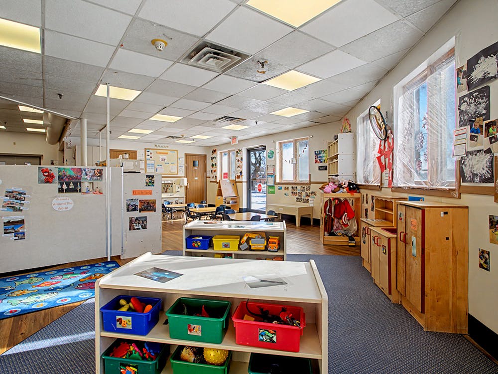 Classroom with toys, cubbies, and windows