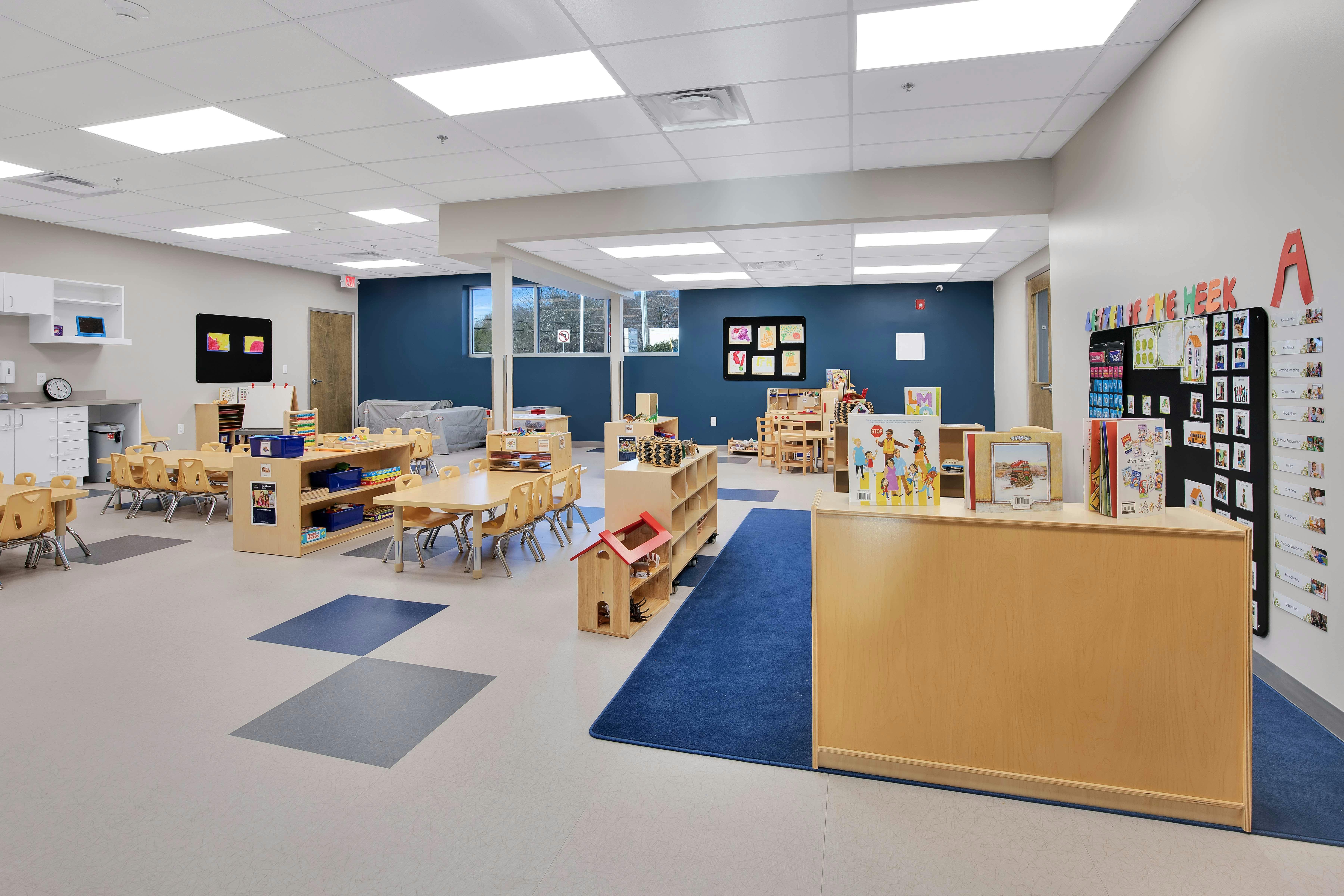 Classroom with small tables, chairs, and learning materials