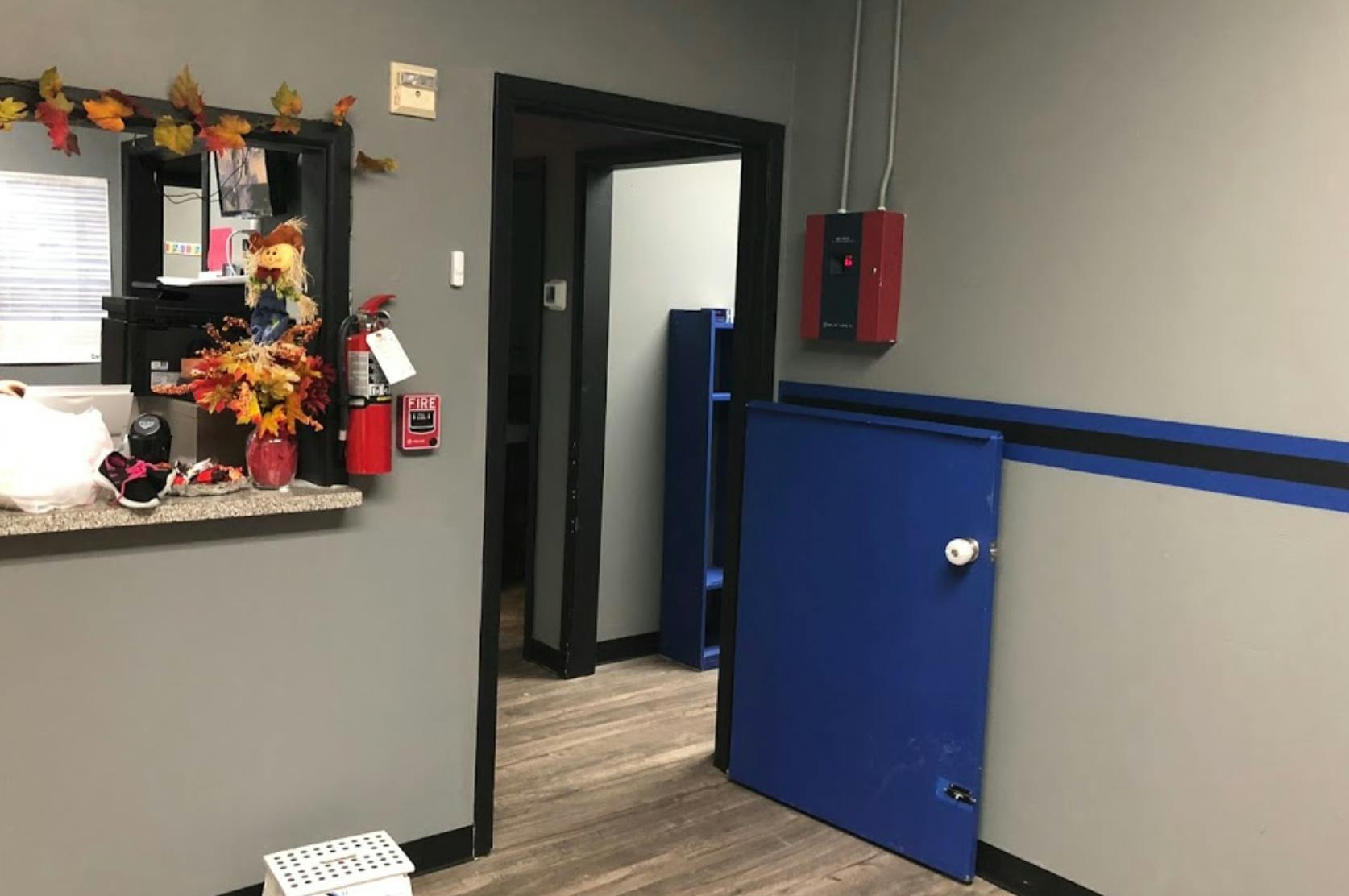 Interior room with a counter, open doorway, and blue half-door