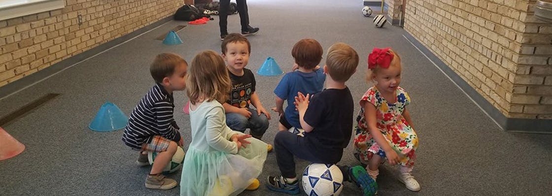 Group of children sitting on the floor in a circle
