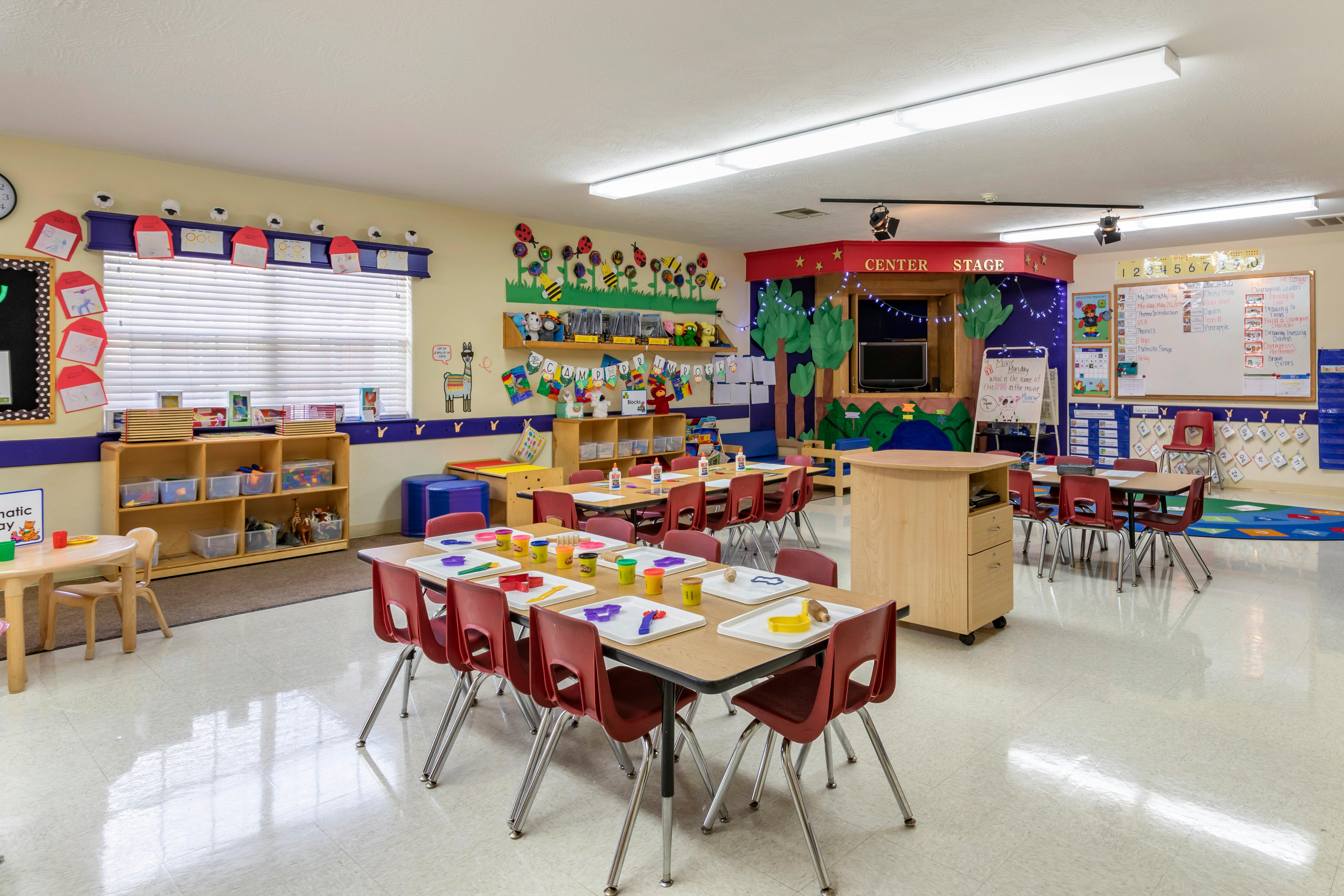 Classroom with tables, chairs, and play areas