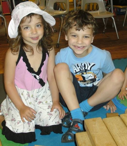 Two children sitting on the floor