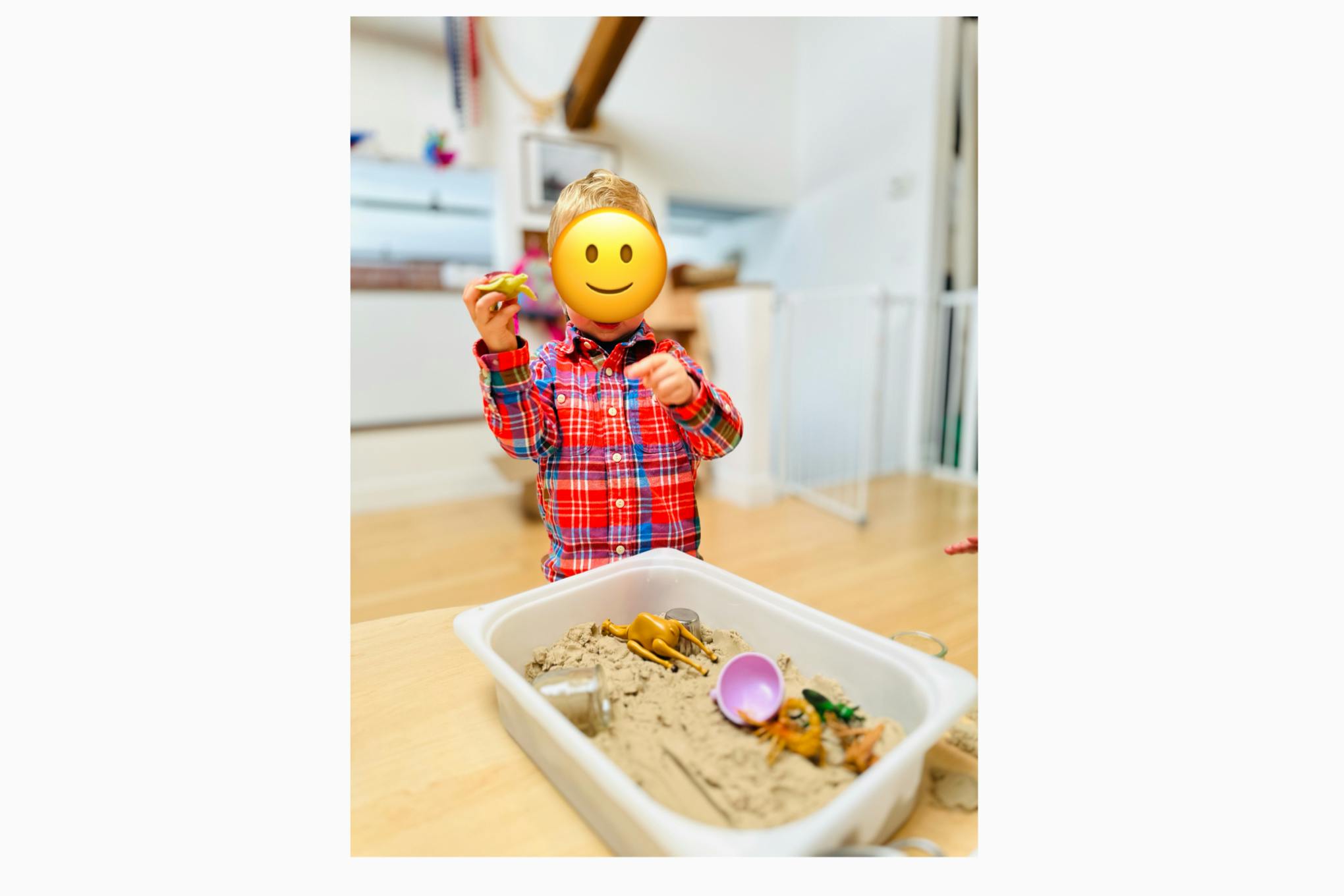 Child playing with sand in a container