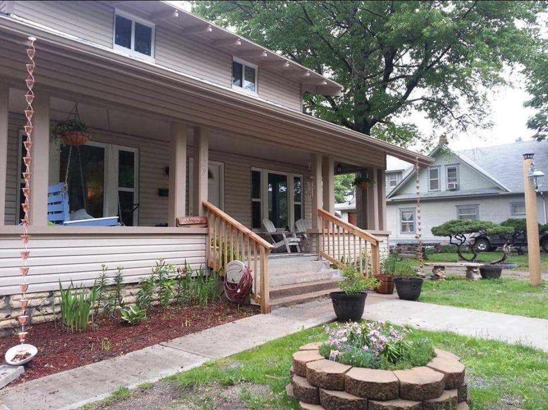 Front exterior of a house with a porch and steps