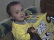 Child holding a yellow toy car