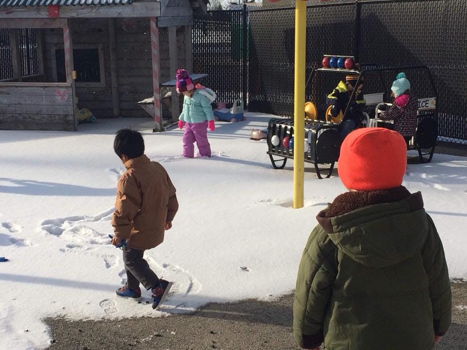 Three children playing in snow