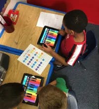 Child using a tablet at a desk