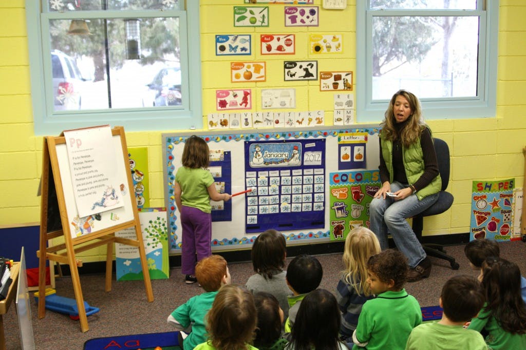 Person teaching children in a classroom