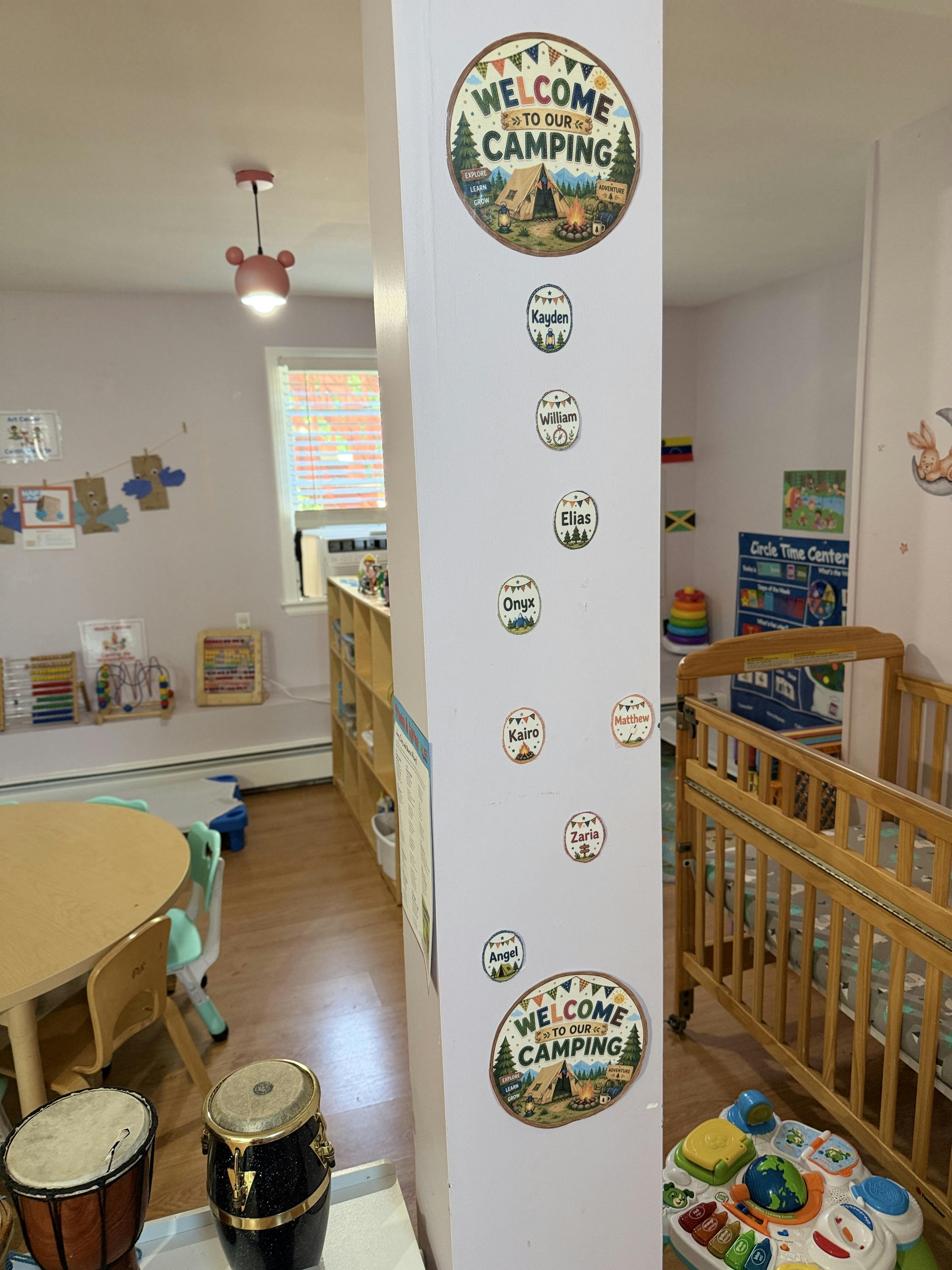 Decorative post with camping-themed name labels in a child care classroom