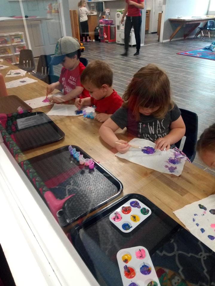 Children painting at a table