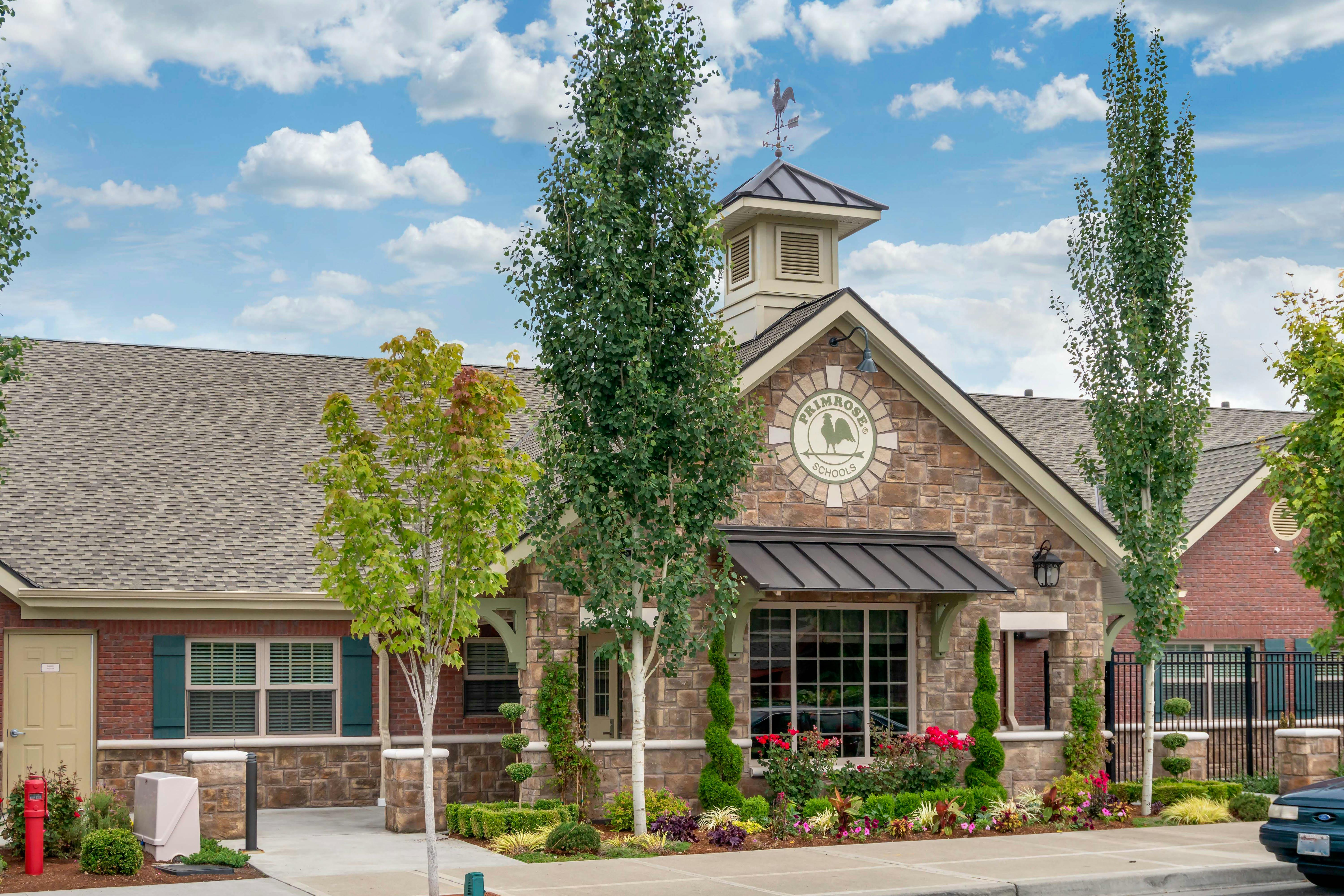 A brick and stone building with a sign that reads "Primrose Schools"