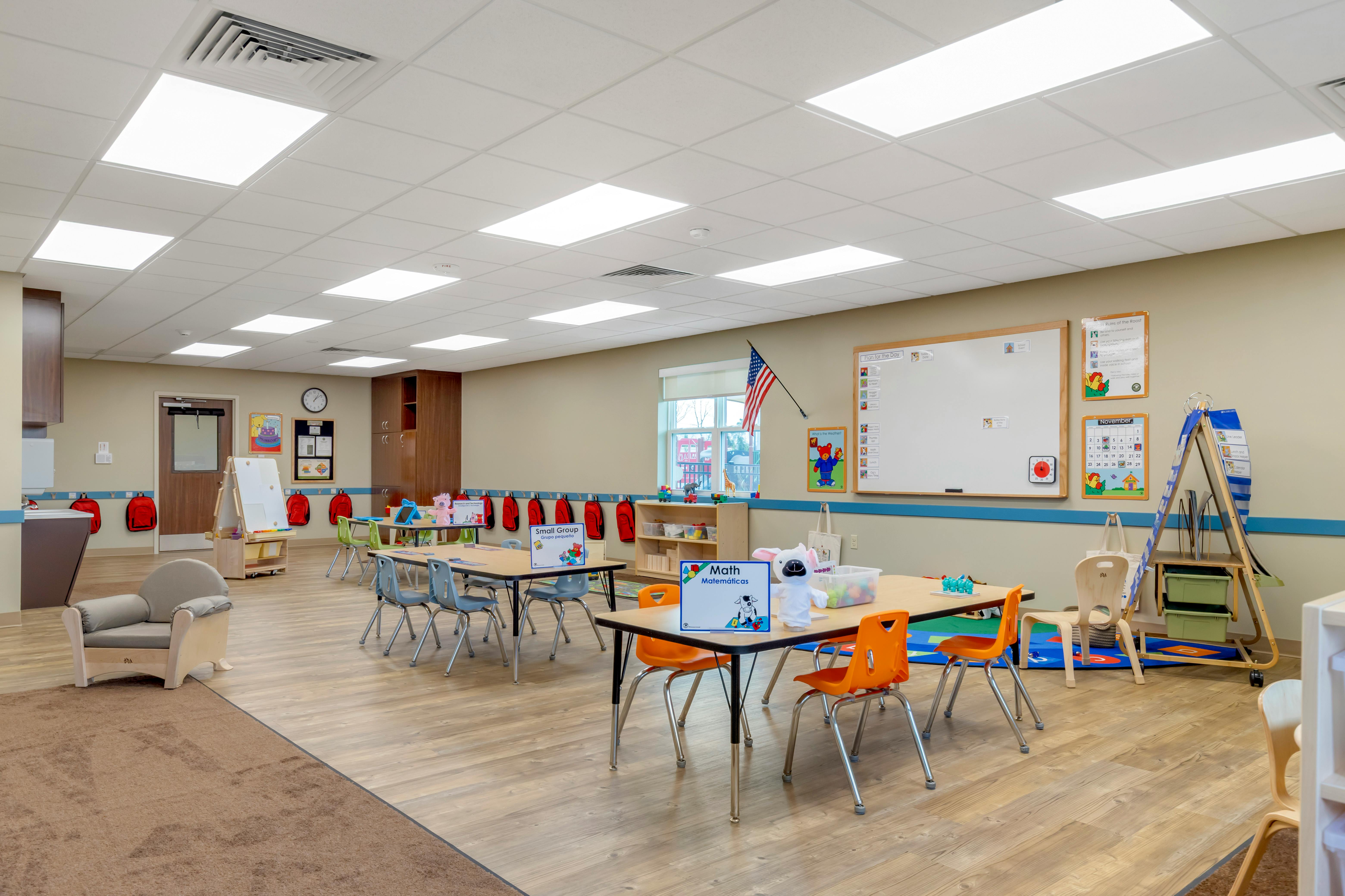 Classroom with small tables, chairs, and learning materials