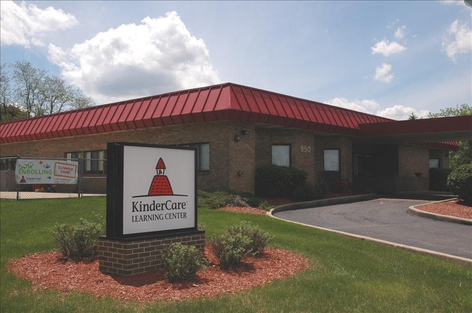 KinderCare Learning Center building with red roof and signage