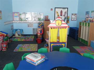 Empty classroom with playhouse and small tables