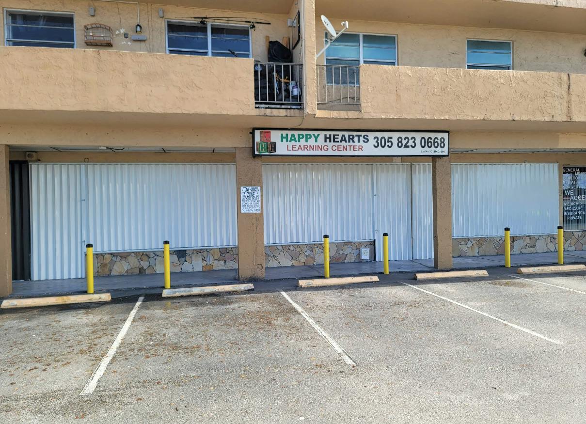 Exterior of Happy Hearts Learning Center with closed white security shutters
