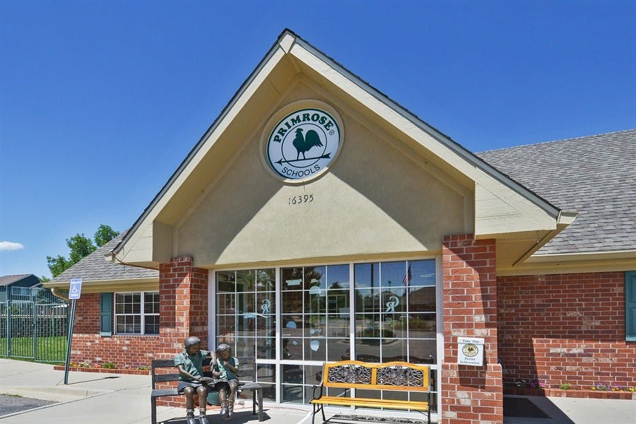 Building with a sign that says "Primrose" and a rooster logo