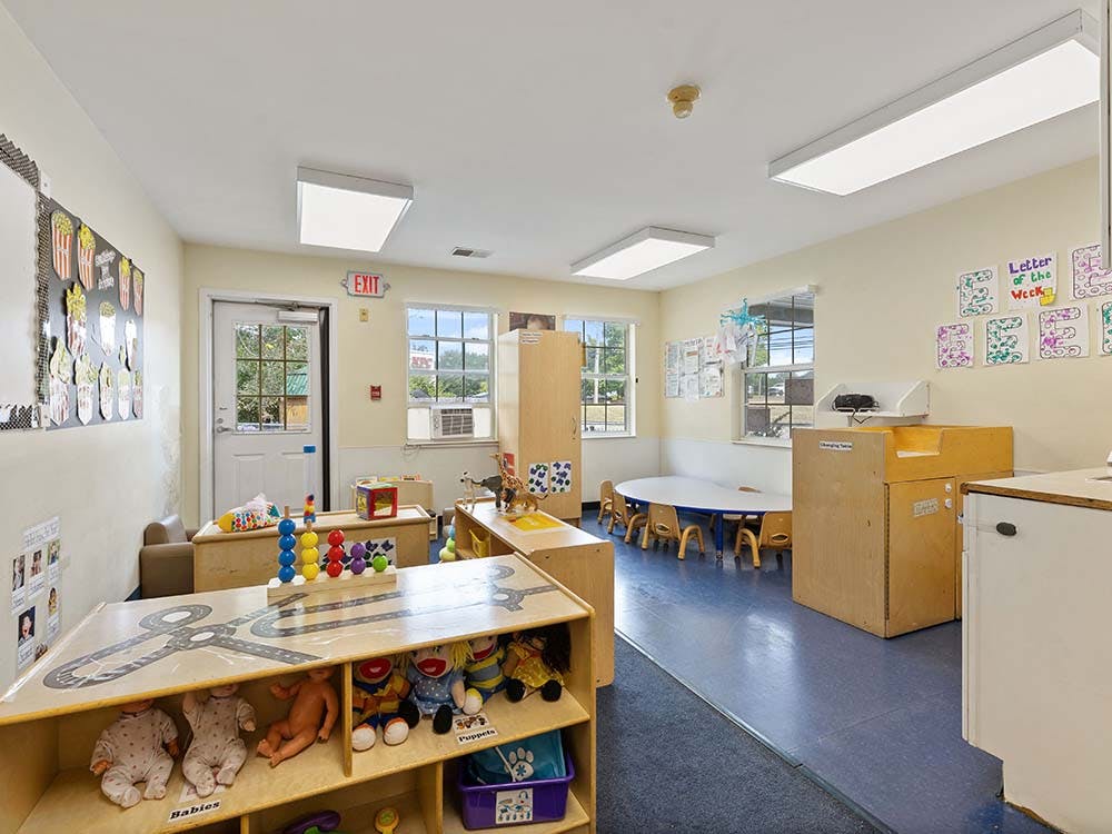 A classroom with toys and small tables