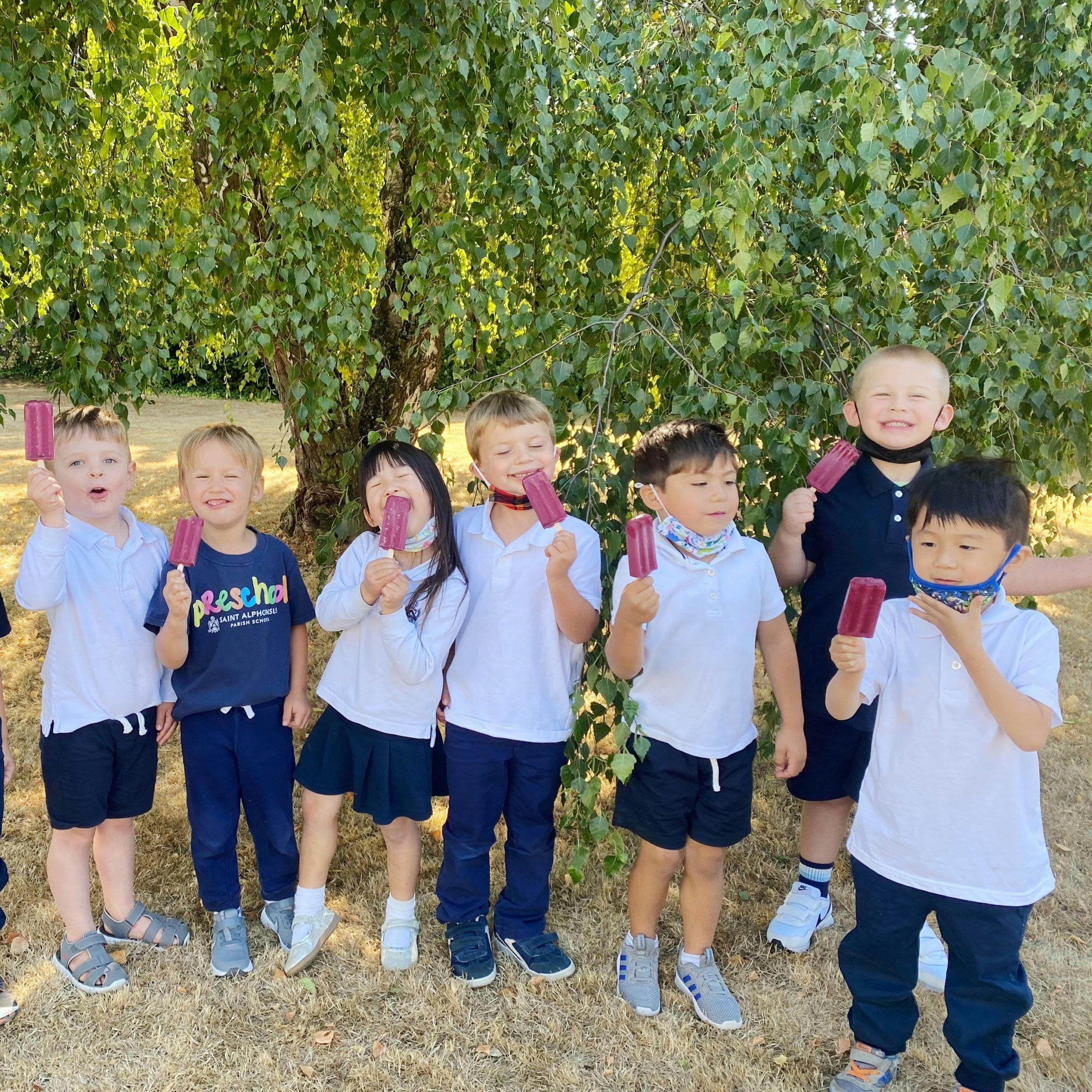 Group of children holding popsicles outdoors
