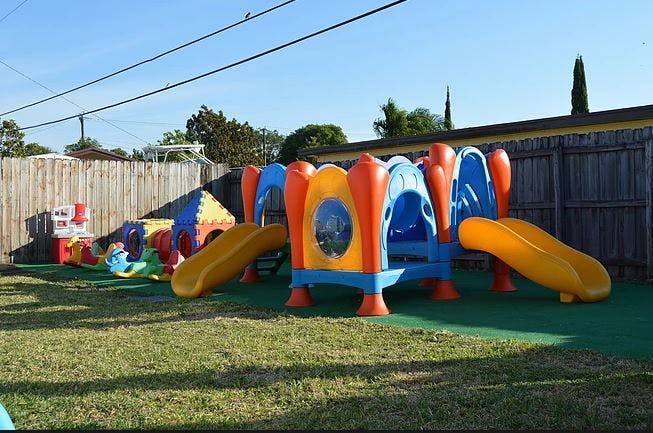 Colorful playground equipment with slides and tunnels on grass