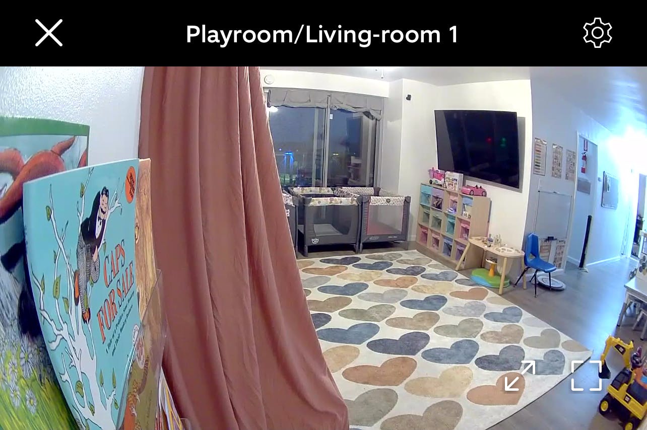 Playroom with two playpens and a heart-patterned rug