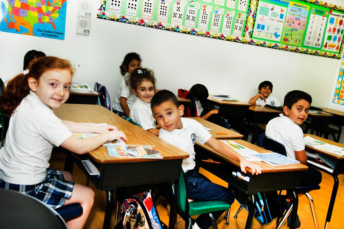 Children sitting at desks in a classroom