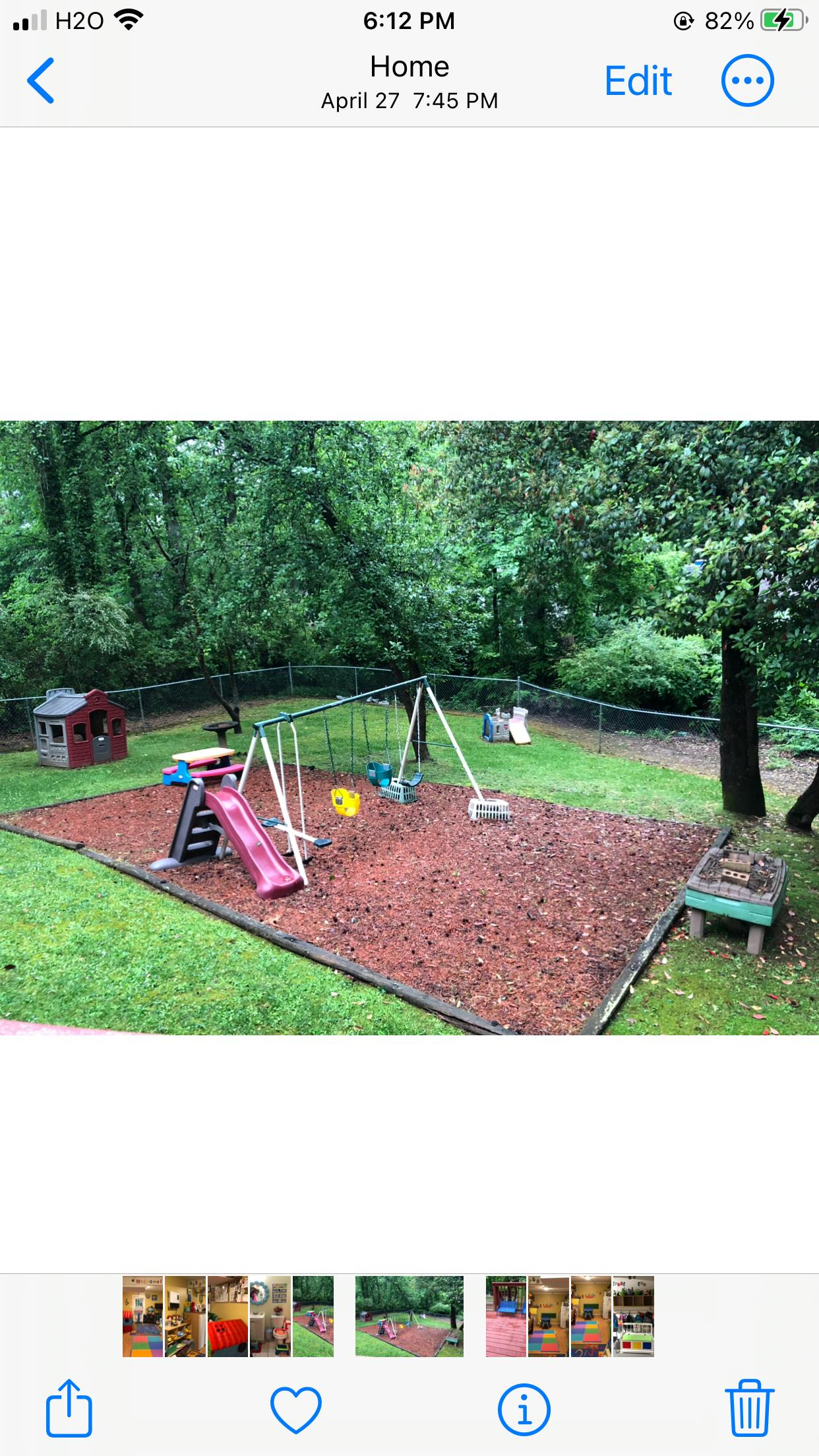 Outdoor playground with swings, slide, and playhouse