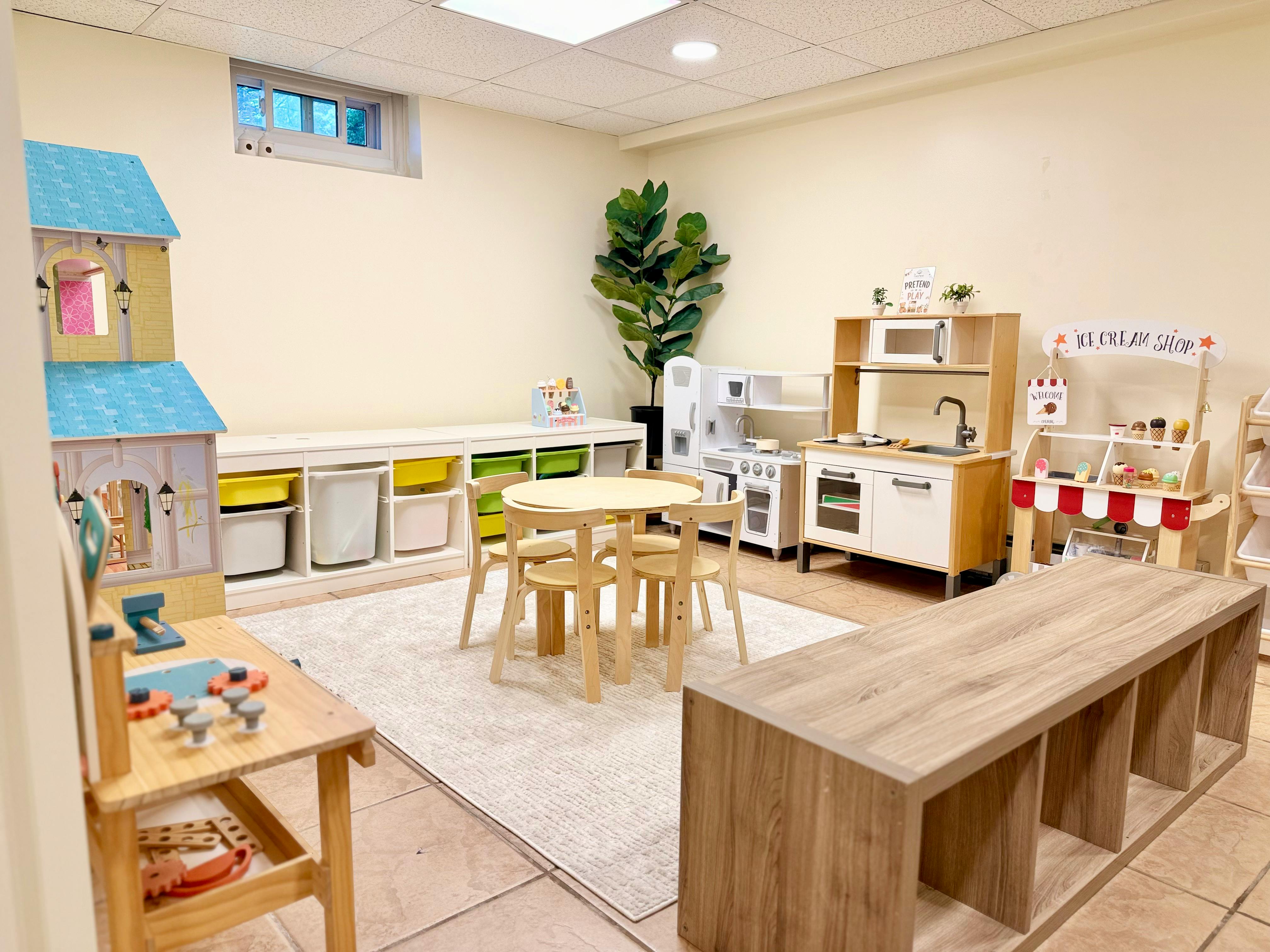 Playroom with children's toy kitchen, ice cream stand, and small table