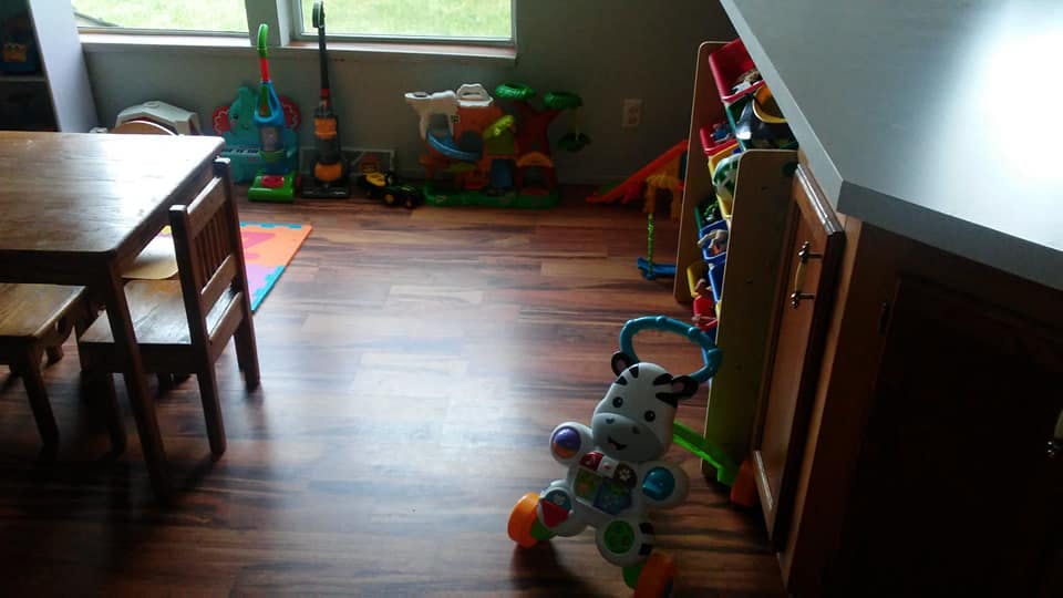 Playroom with a small table and chairs, toys on the floor